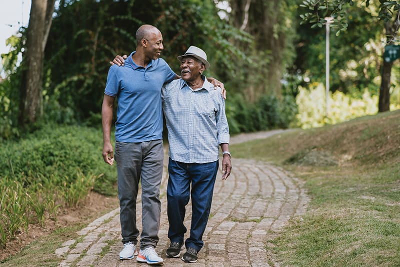 Portrait of elderly father and adult son walking